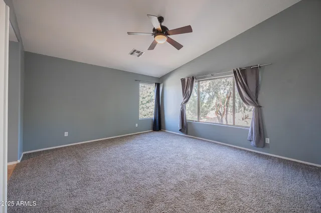 a view of a livingroom with a ceiling fan and window