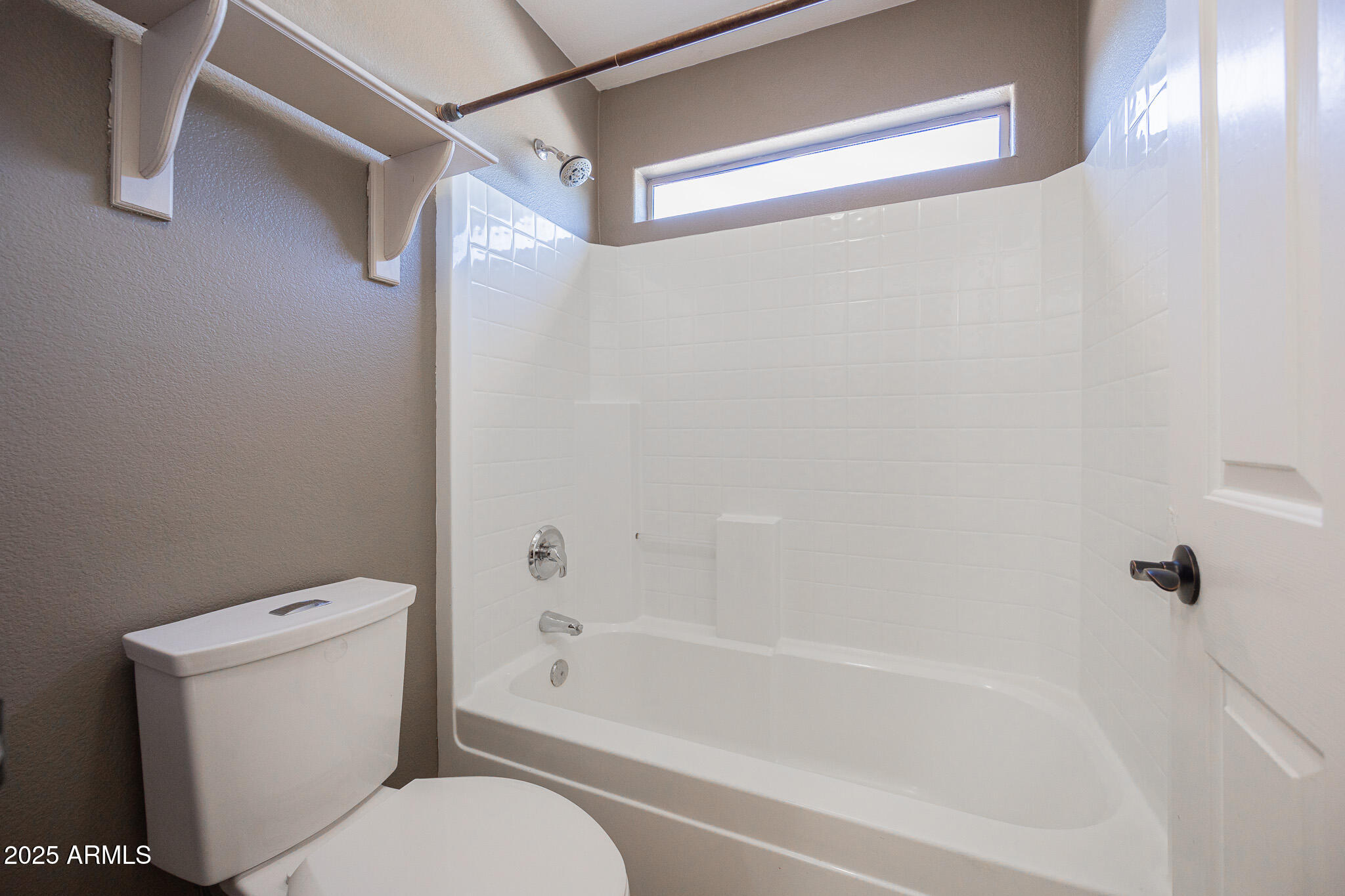 2300 East Augusta Avenue Chandler, AZ 85249 - Photo 38 of 53 a white toilet sitting next to a bath tub