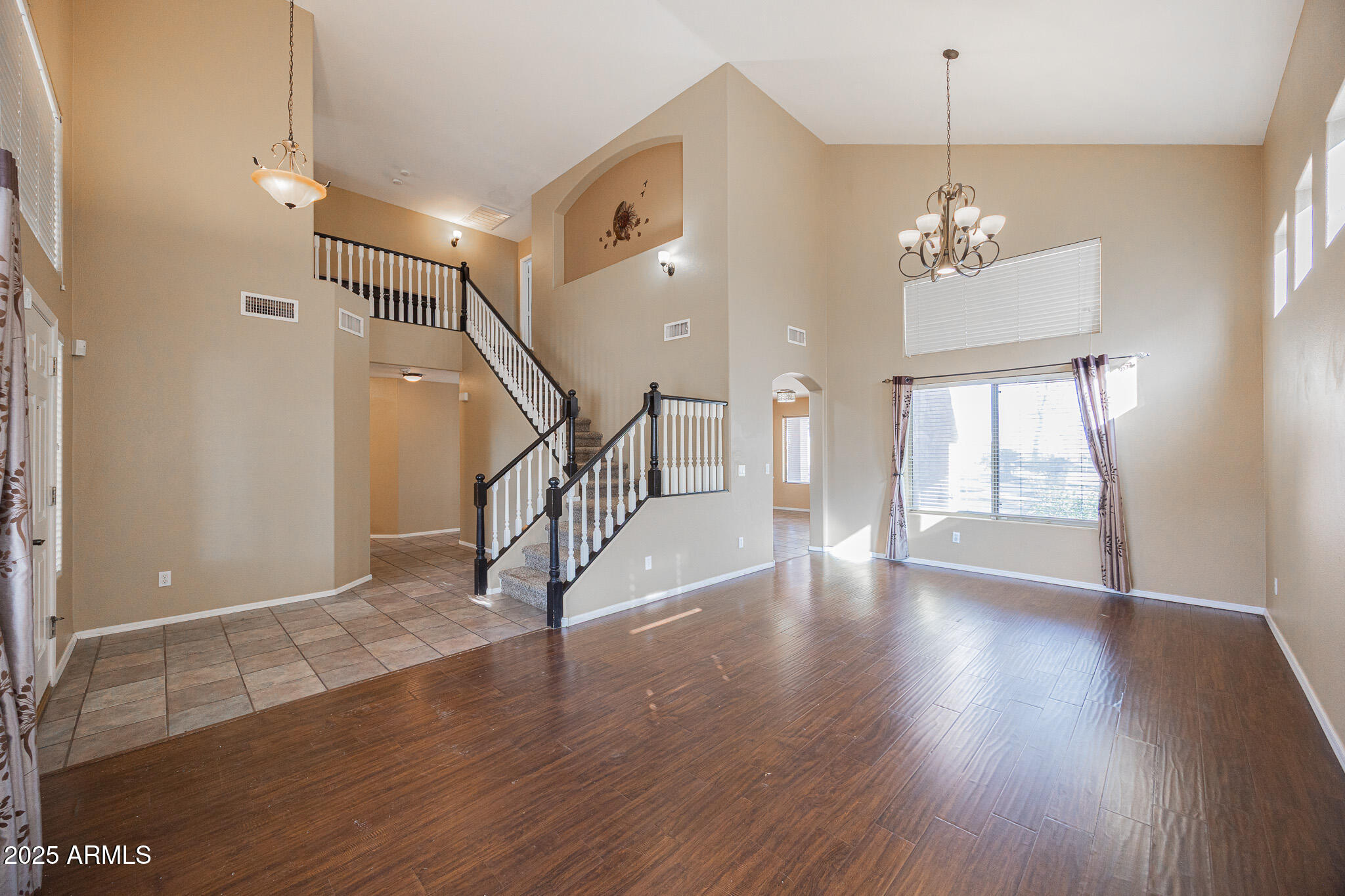 2300 East Augusta Avenue Chandler, AZ 85249 - Photo 6 of 53 a view of an empty room with wooden floor and a window