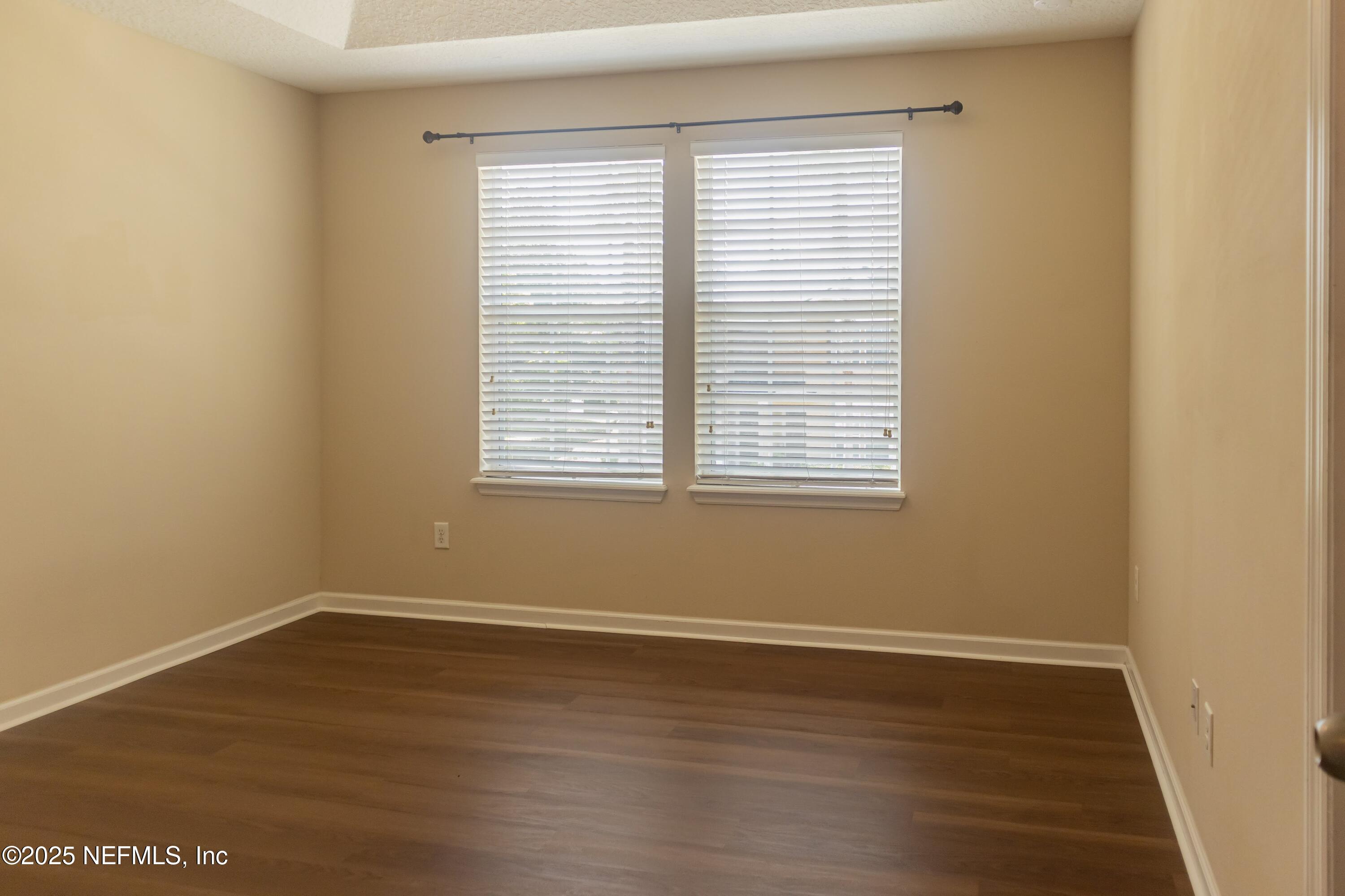 4220 Plantation Oaks Boulevard, Unit 1714 Orange Park, FL 32065 - Photo 11 of 11 wooden floor in an empty room with a window