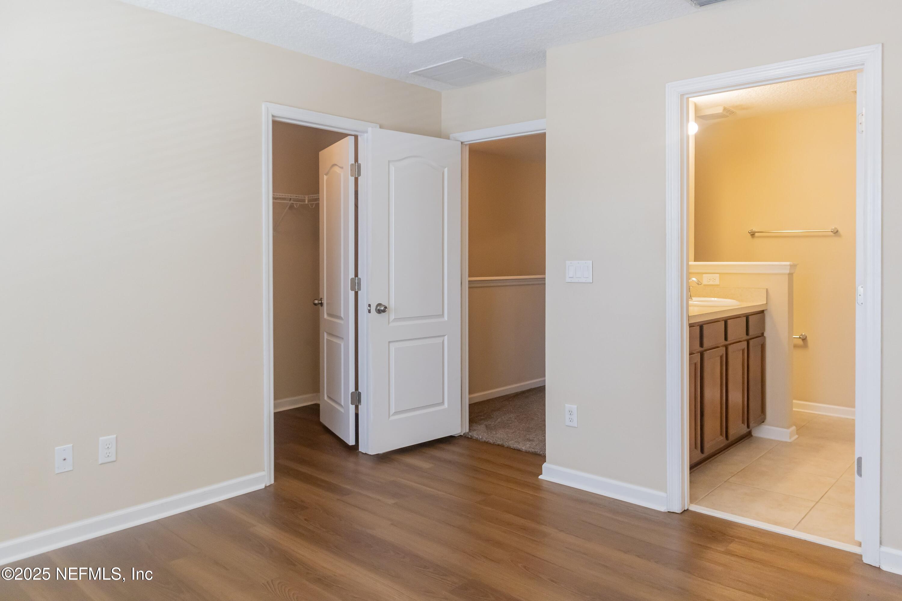 4220 Plantation Oaks Boulevard, Unit 1714 Orange Park, FL 32065 - Photo 6 of 11 an empty room with wooden floor and a window