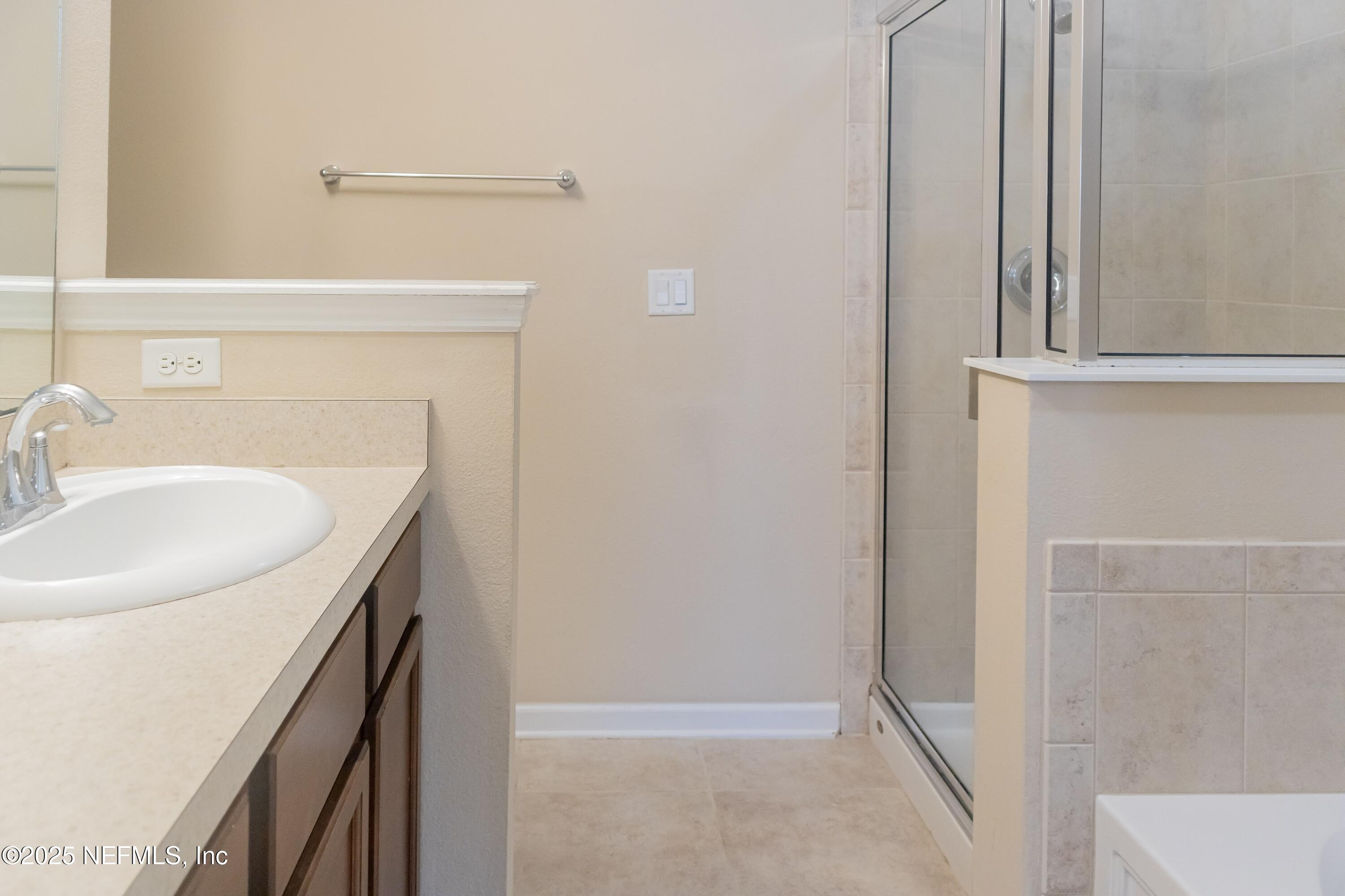 4220 Plantation Oaks Boulevard, Unit 1714 Orange Park, FL 32065 - Photo 7 of 11 a bathroom with a sink and a mirror