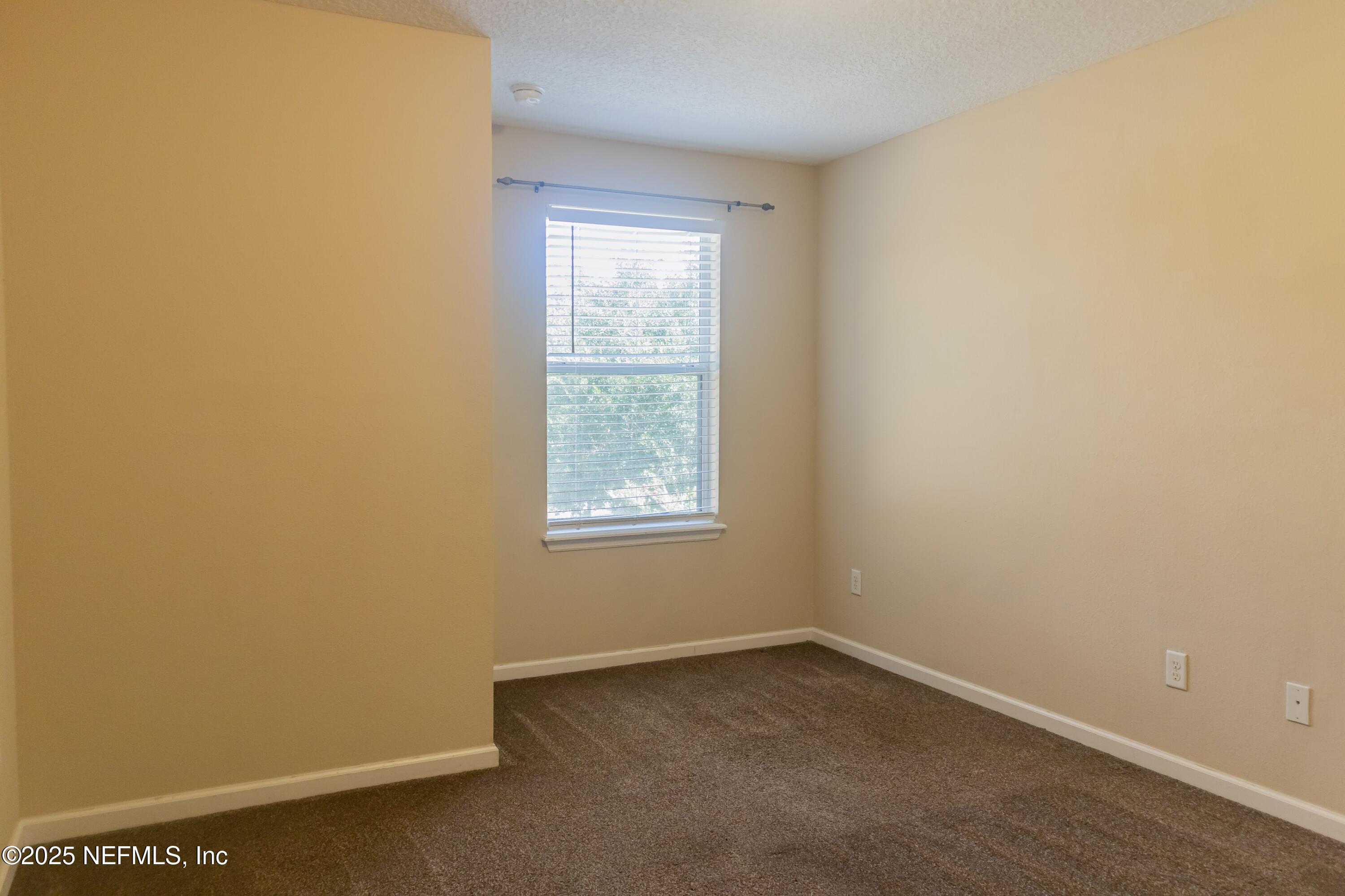 4220 Plantation Oaks Boulevard, Unit 1714 Orange Park, FL 32065 - Photo 8 of 11 an empty room with a window