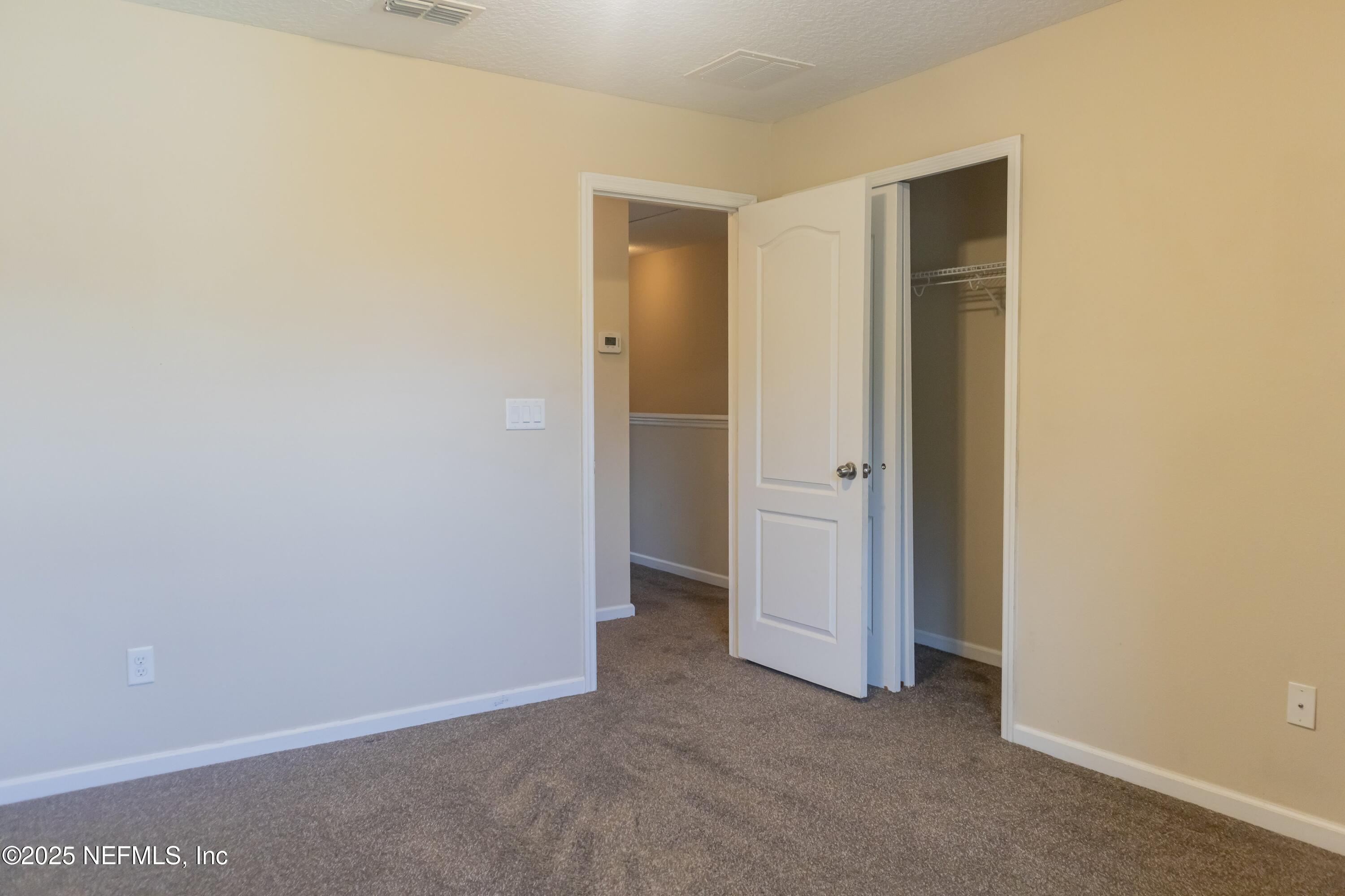 4220 Plantation Oaks Boulevard, Unit 1714 Orange Park, FL 32065 - Photo 9 of 11 an empty room with closet