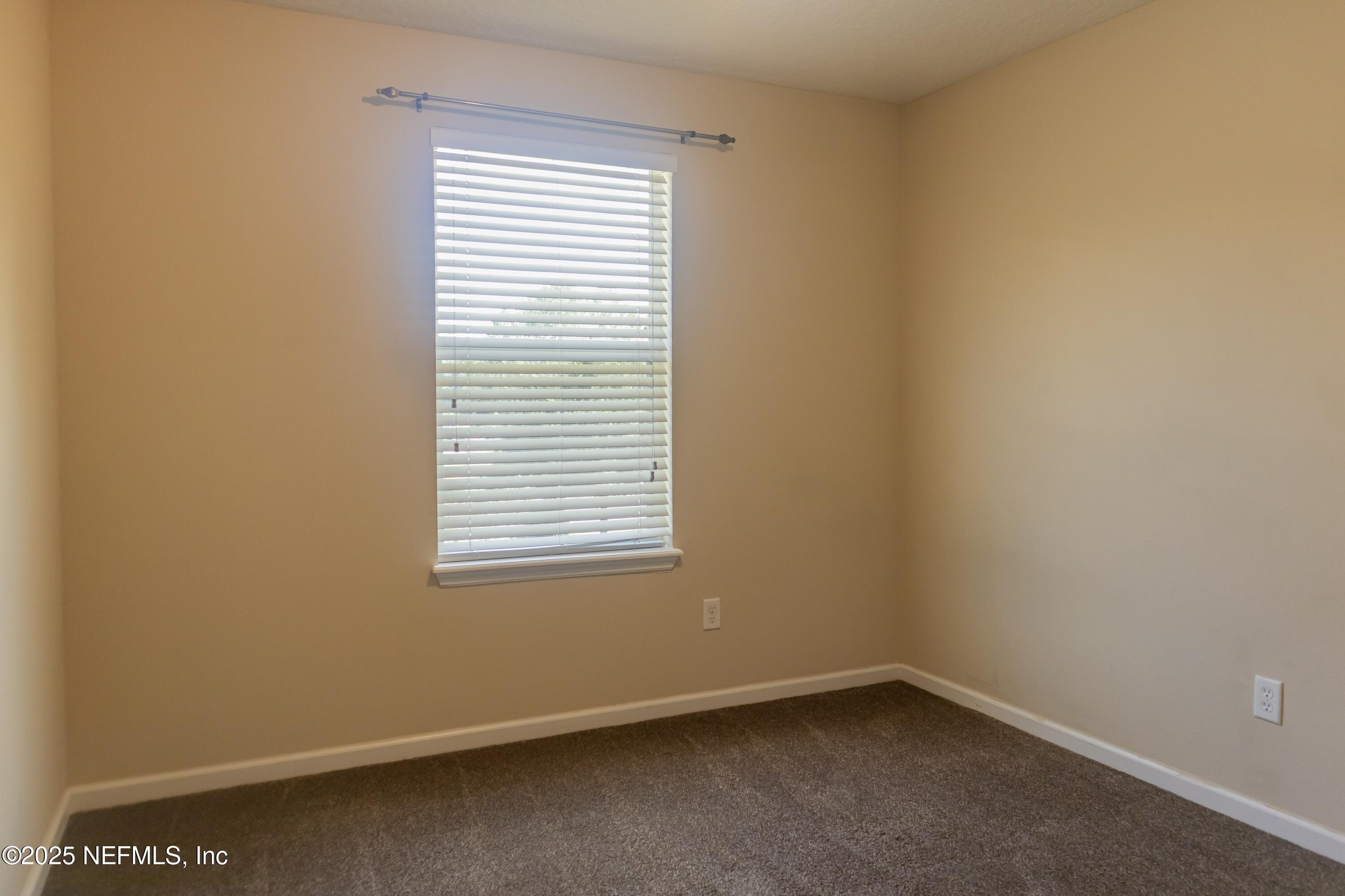 4220 Plantation Oaks Boulevard, Unit 1714 Orange Park, FL 32065 - Photo 10 of 11 an empty room with a window