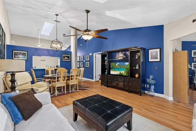 a living room with furniture a dining table and a flat screen tv