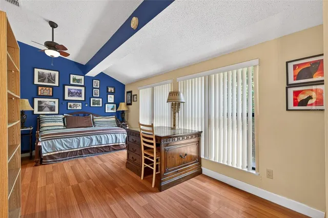 a bedroom with furniture and wooden floor