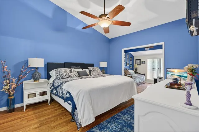 a bedroom with bed and a chandelier