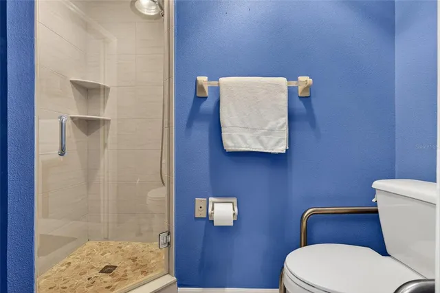 a white toilet sitting next to a bathroom sink