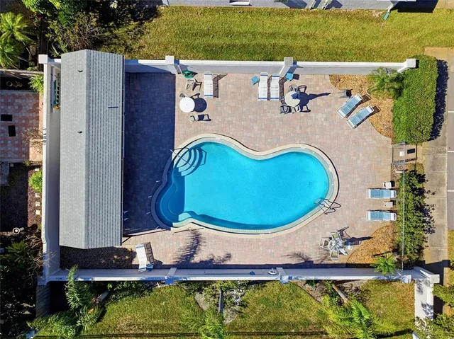 an aerial view of a house with garden space and outdoor seating