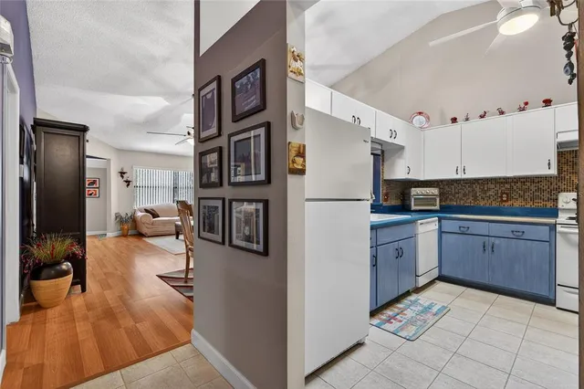 a kitchen with stainless steel appliances granite countertop a refrigerator and a stove