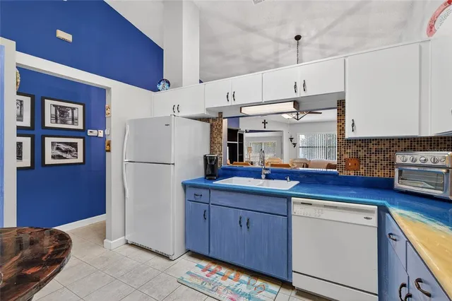 a kitchen with refrigerator and cabinets