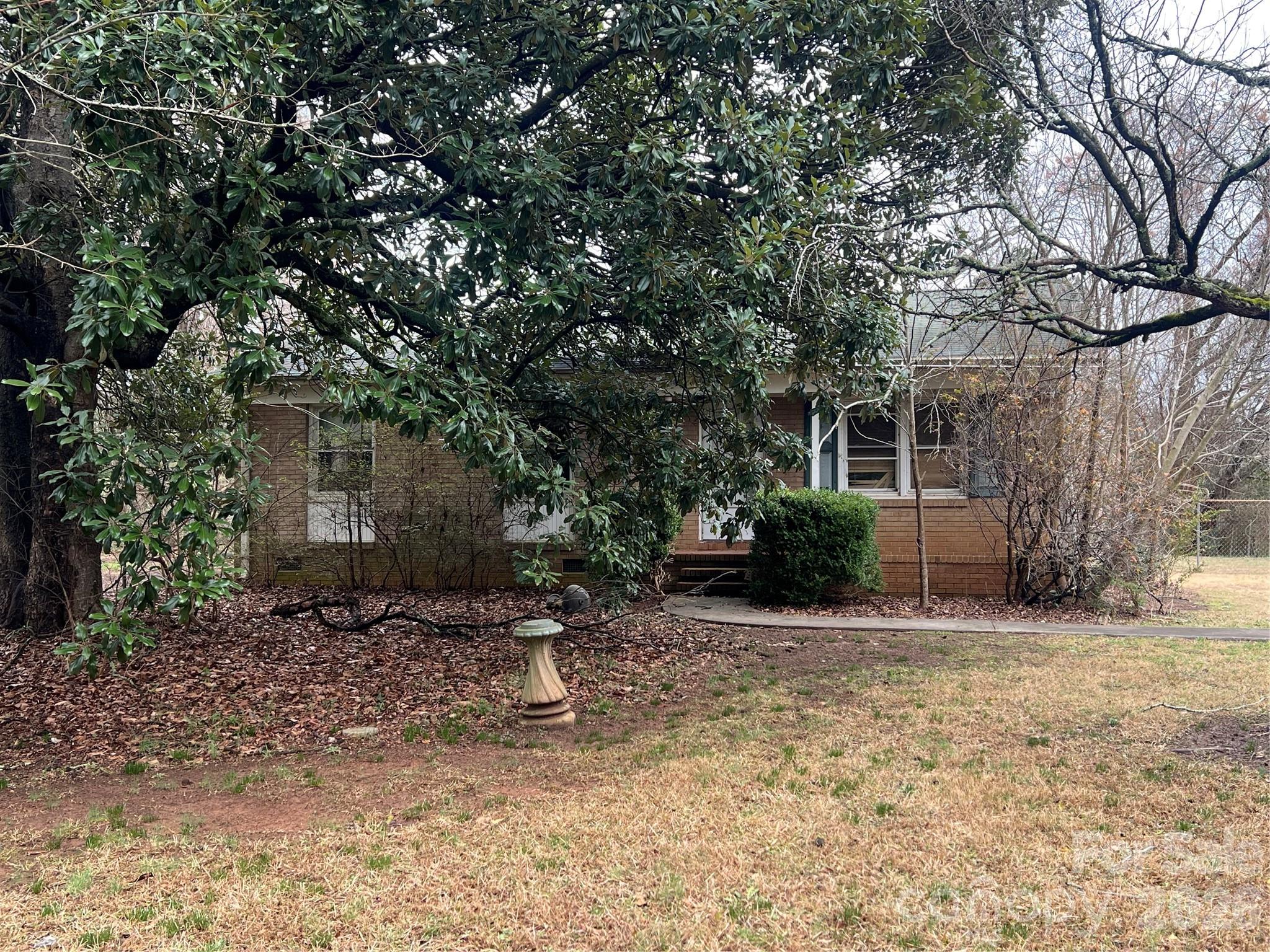 9970 Harrisburg Road Fort Mill, SC 29707 - Photo 3 of 9 a backyard of a house with potted plants and large tree