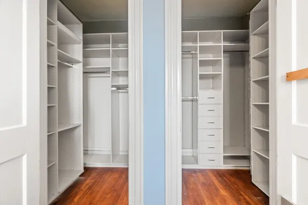 a view of walk in closet with empty racks