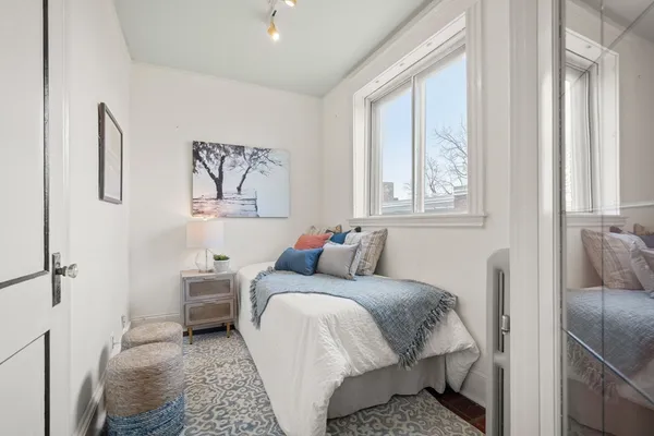 a bed room with a bed and a window