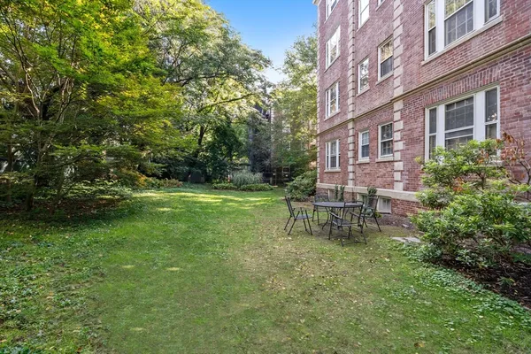 a view of a chair and table in the backyard of the house