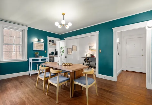 a view of a dining room with furniture and wooden floor