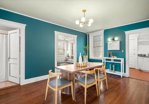 a view of a dining room with furniture wooden floor and chandelier