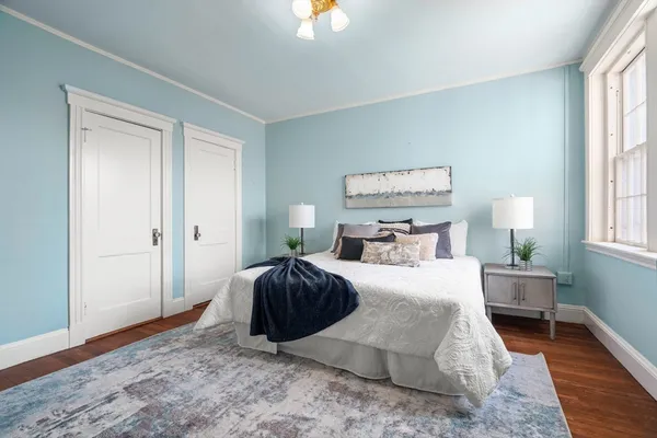a bedroom with a bed and window