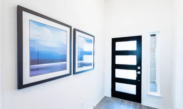 a kitchen with a dining table chairs refrigerator and microwave