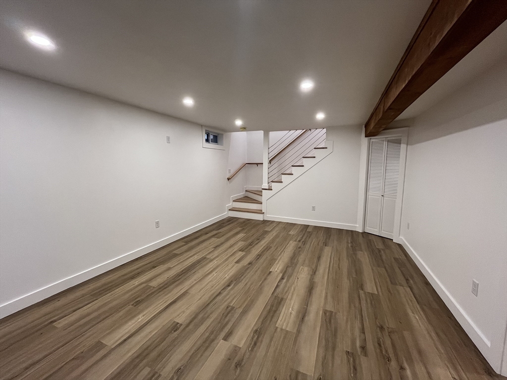 76 Sippewissett Road Falmouth, MA 02540 - Photo 21 of 28 an empty room with wooden floor and white walls