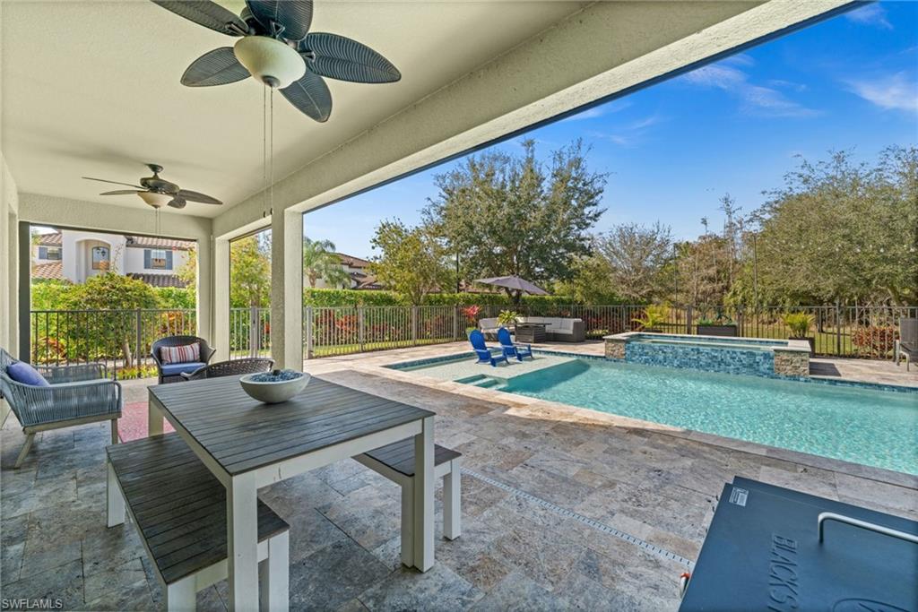 4754 Abaca Circle Naples, FL 34119 - Photo 35 of 46 a view of a porch with furniture and a yard