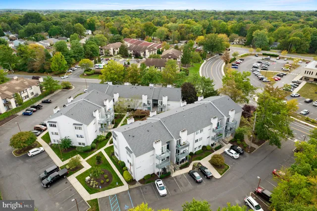 an aerial view of multiple houses with yard