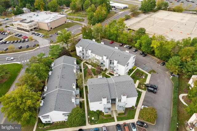 an aerial view of multiple houses with yard
