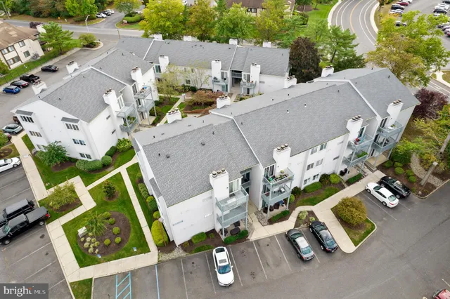 an aerial view of multiple houses with yard