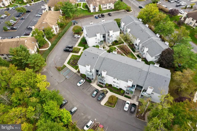 an aerial view of multiple houses with yard