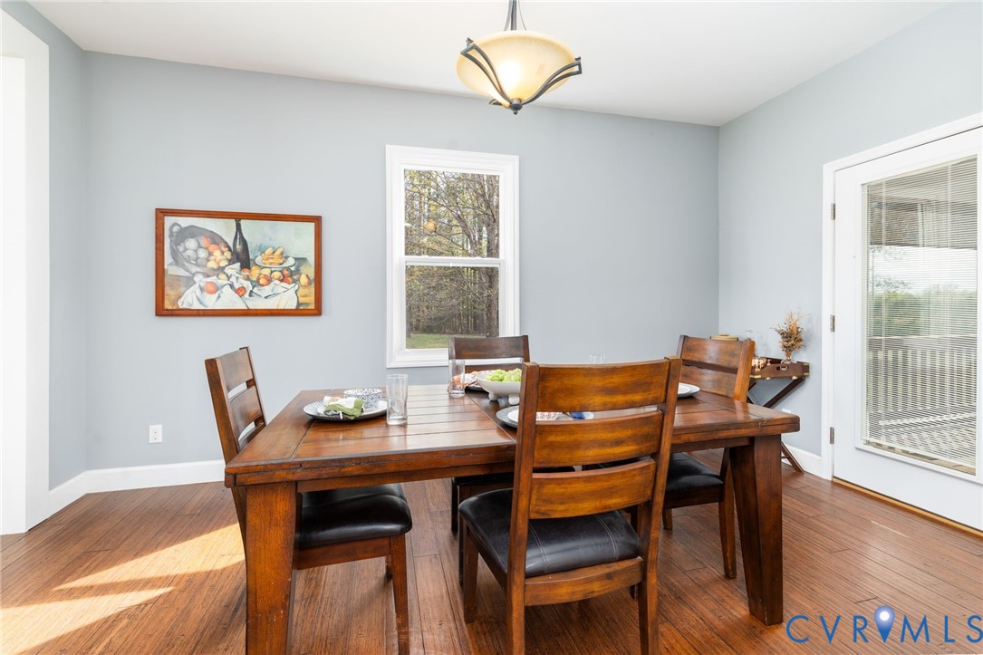 1895 Cemetery Road Chase City, VA 23924 - Photo 16 of 83 a view of a dining room with furniture wooden floor and a chandelier