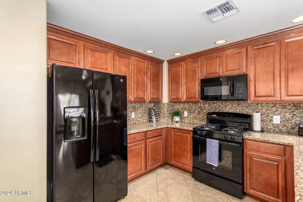 a kitchen with a refrigerator stove and microwave