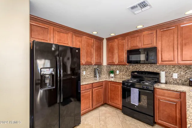 a kitchen with a refrigerator stove and microwave