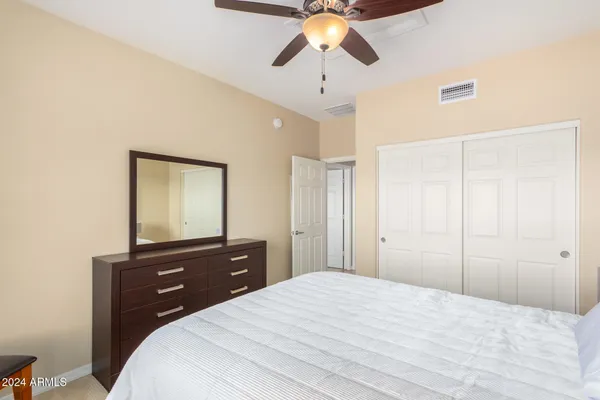 a bedroom with a bed and a dresser