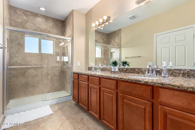 a bathroom with a granite countertop sink mirror and double