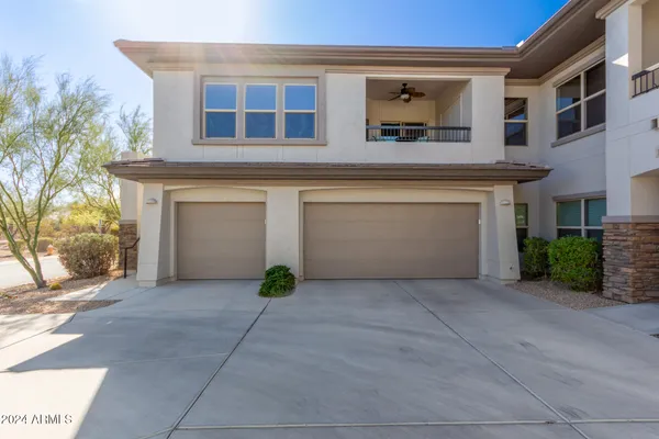 a view of a house with a yard and garage