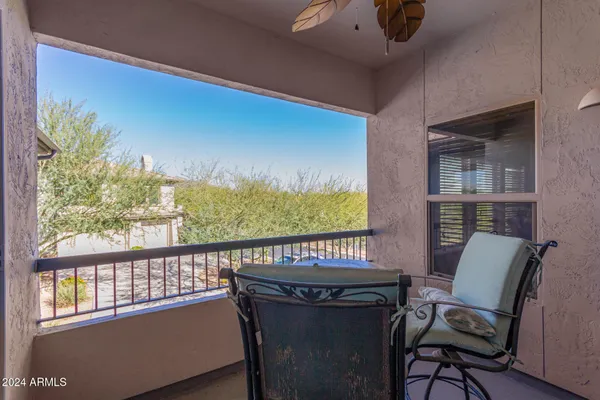 a view of a chairs and table in a balcony