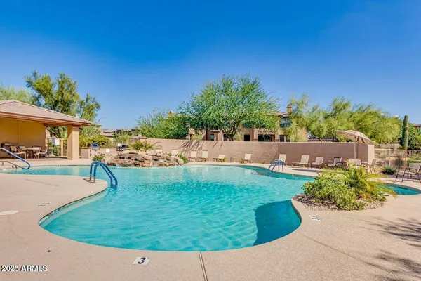 a view of a swimming pool with a yard
