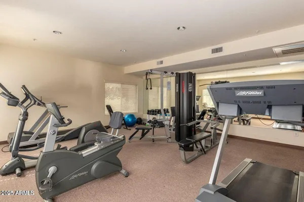a room with gym equipment and windows