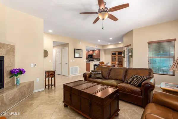 a living room with furniture kitchen and a chandelier
