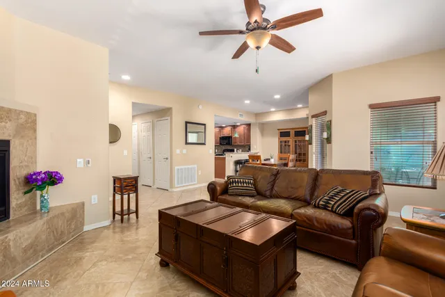 a living room with furniture kitchen and a chandelier