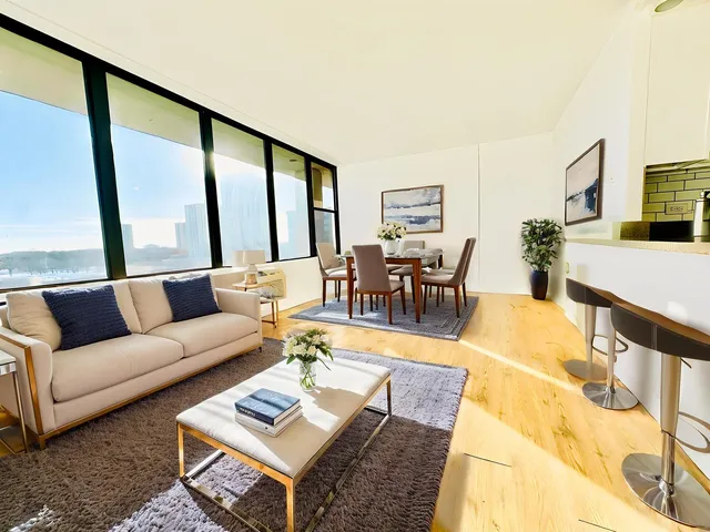 a swimming pool with a large window and wooden floor