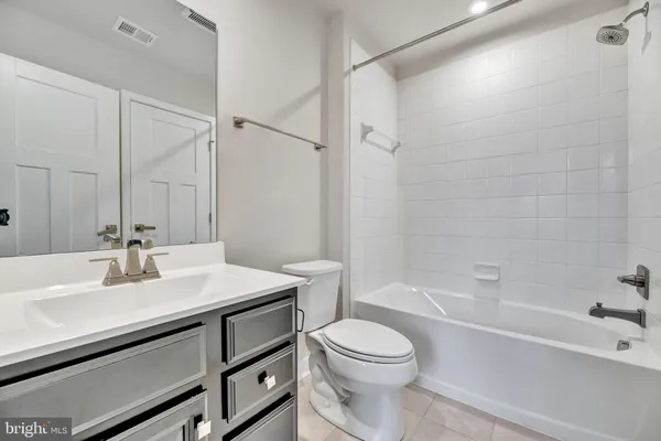 a bathroom with a sink a toilet and a bathtub