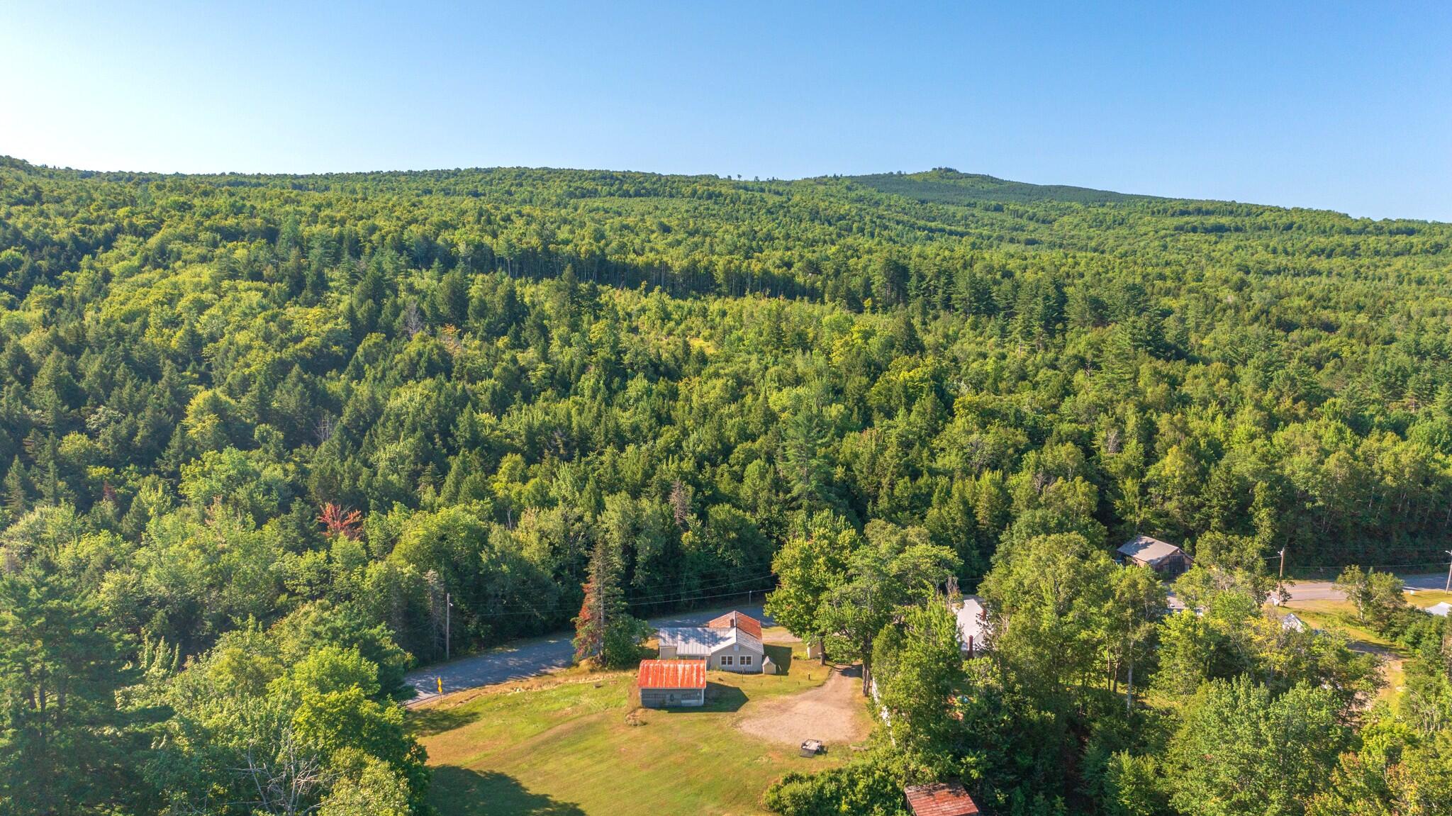 773 Pleasant Ridge Road Bingham, ME 04920 - Photo 5 of 67 rear hill sky and house