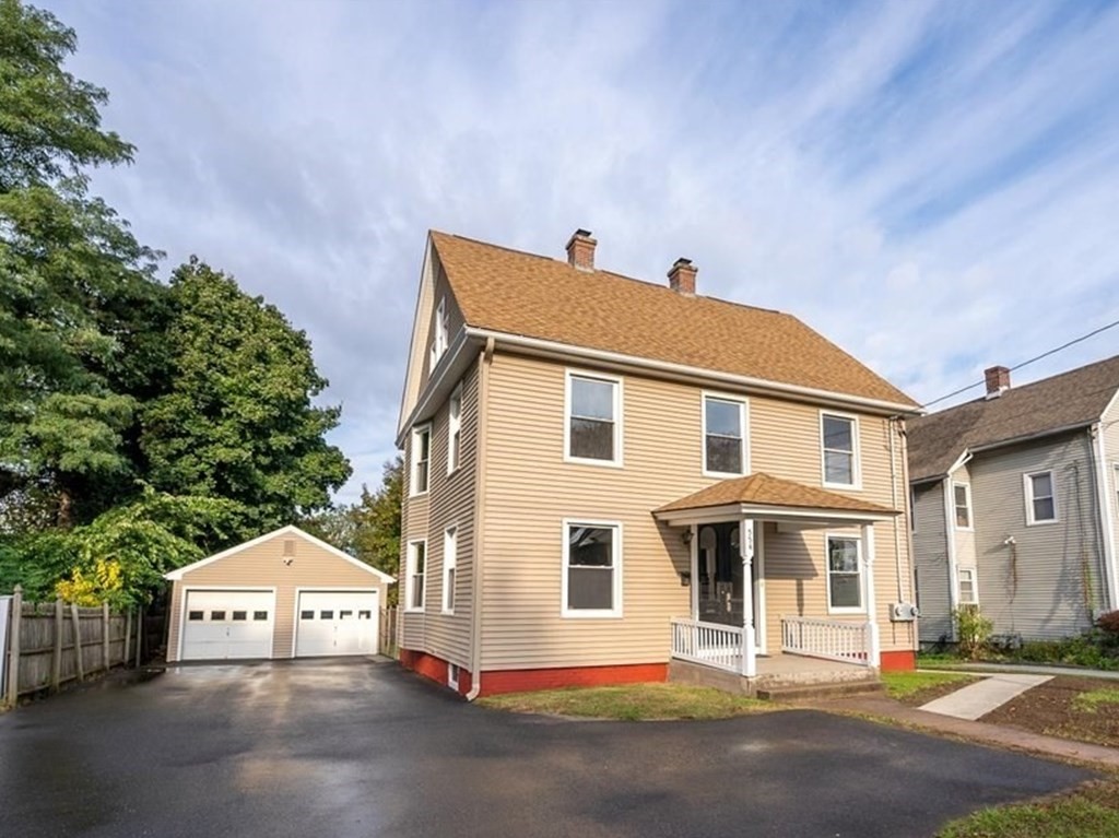 a front view of a residential houses with yard