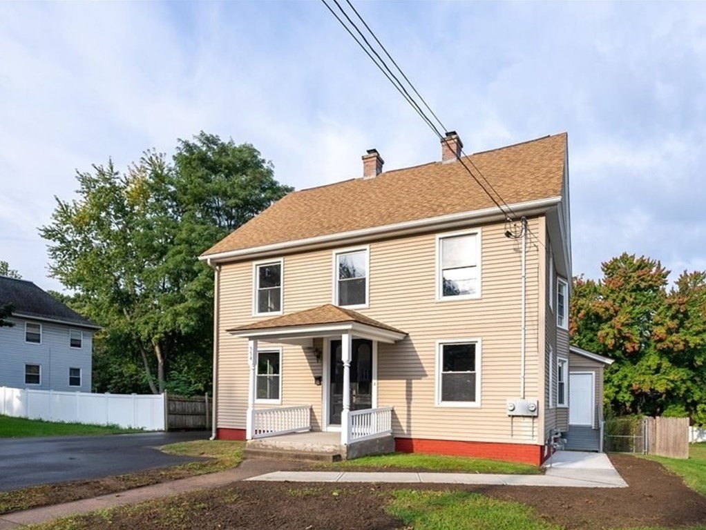 554 Broadway Street Chicopee, MA 01020 - Photo 2 of 42 a front view of a house with a yard