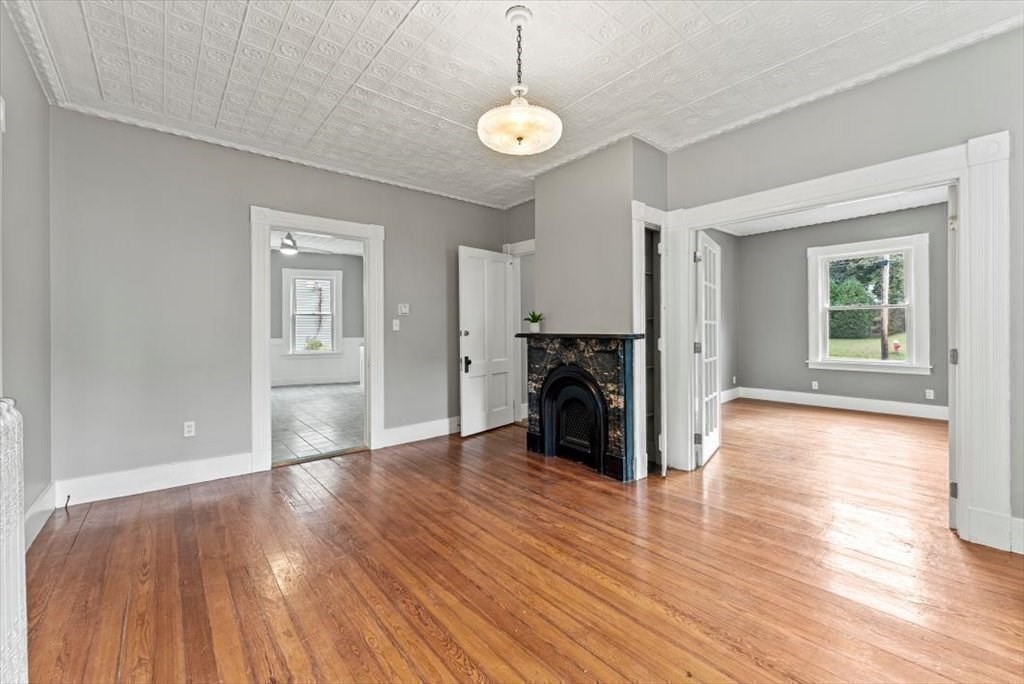 554 Broadway Street Chicopee, MA 01020 - Photo 24 of 42 a view of a kitchen with a fridge wooden floor and a window