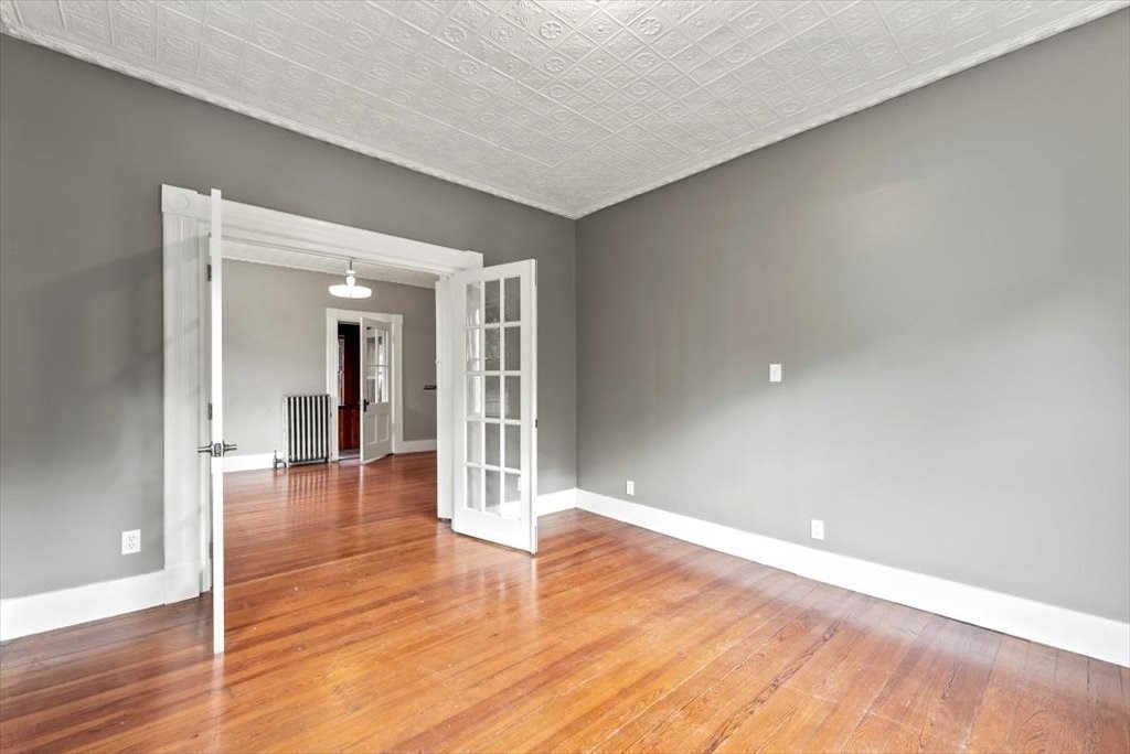 554 Broadway Street Chicopee, MA 01020 - Photo 28 of 42 a view of an empty room and wooden floor