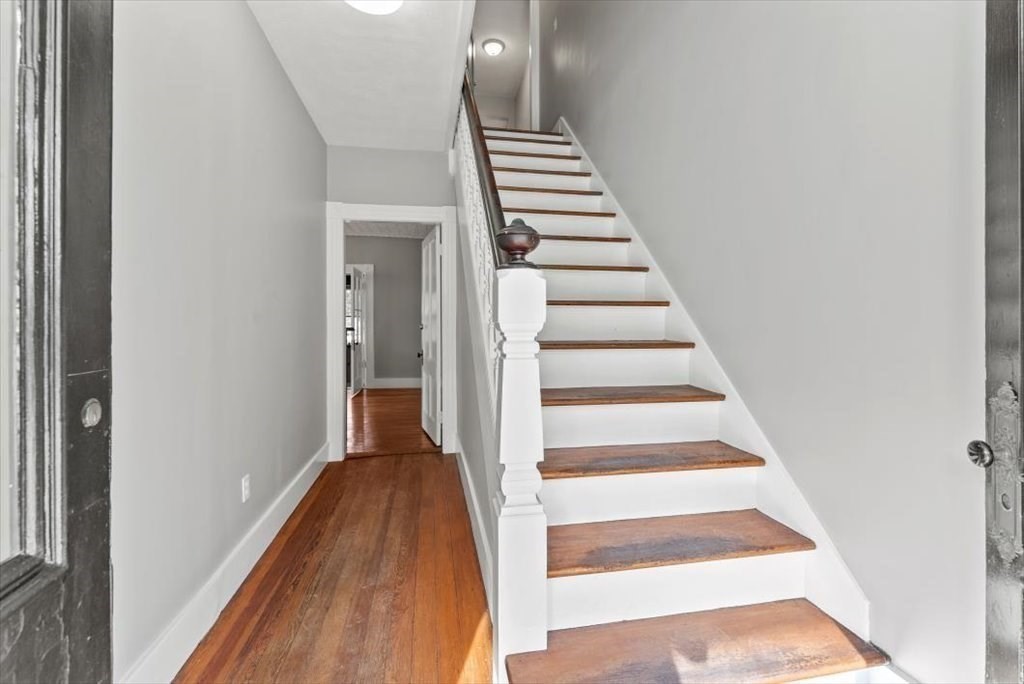 554 Broadway Street Chicopee, MA 01020 - Photo 6 of 42 a view of a hallway with wooden floor and entryway