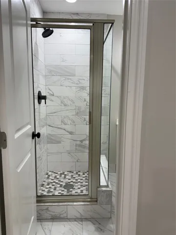 a bathroom with a glass shower door
